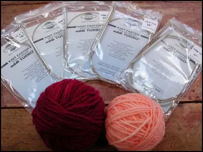 Circular knitting needles and wool on a wooden table