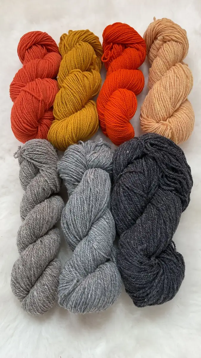 Orange, yellow, natural, and grey Philosopher’s Wool skeins