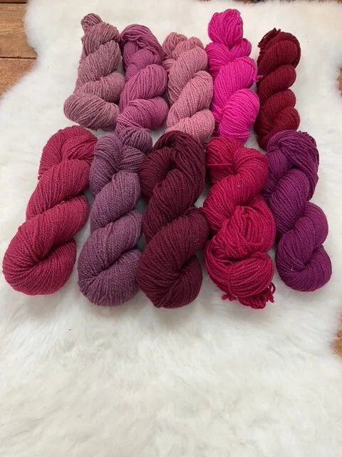 Rose, pink, raspberry, and maroon Philosopher’s Wool skeins