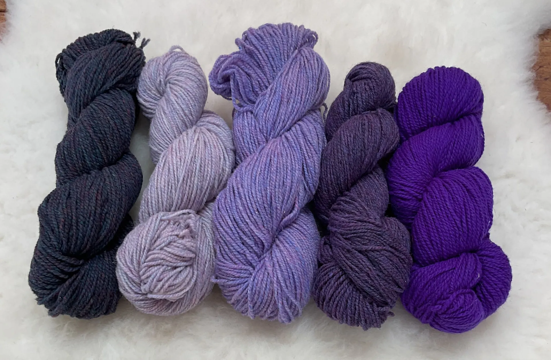 Grape, purple heather, mist, and barbecue Philosopher’s Wool skeins