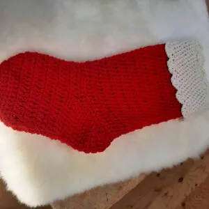 A red and white hand-knit Christmas stocking