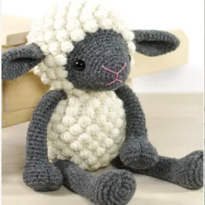 A crocheted wool sheep seated on a table