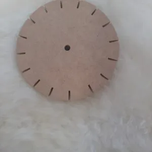 A round kumihimo braiding disk on white wool